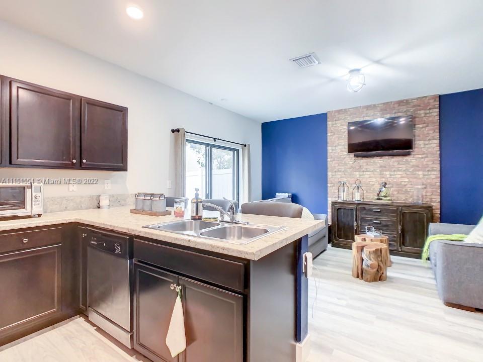 9326 West 33rd Lane Hialeah, FL 33018 - Photo 9 of 52 a kitchen with a sink and a stove top oven