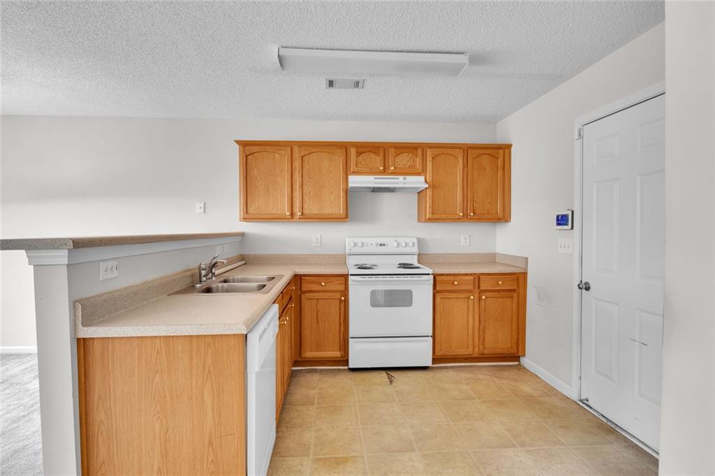 7243 April Court Morrow, GA 30260 - Photo 11 of 29 a kitchen with a sink a stove and cabinets