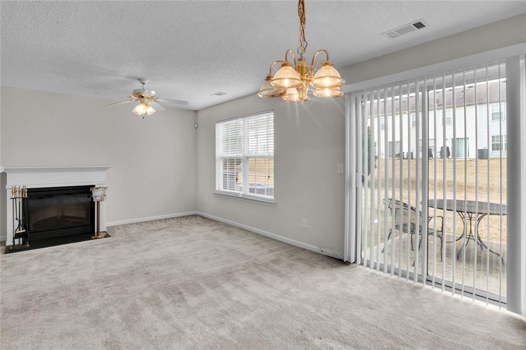 7243 April Court Morrow, GA 30260 - Photo 5 of 29 a view of a livingroom with a chandelier fan and windows