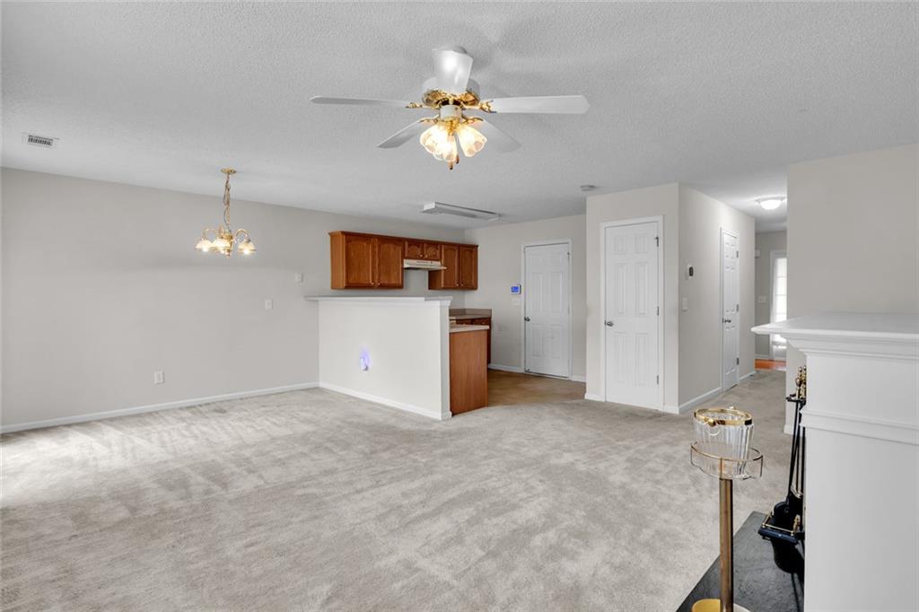 7243 April Court Morrow, GA 30260 - Photo 7 of 29 a view of a kitchen with a sink cabinet a refrigerator and a chandelier