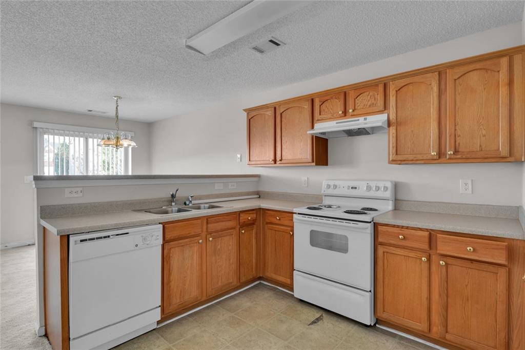7243 April Court Morrow, GA 30260 - Photo 10 of 29 a kitchen with a sink stove and cabinets
