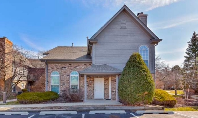 35 Foxcroft Road, Unit 103 Naperville, IL 60565 - Photo 1 of 11 a front view of a house with a yard