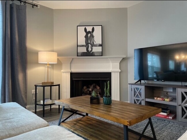 35 Foxcroft Road, Unit 103 Naperville, IL 60565 - Photo 3 of 11 a living room with furniture and a fireplace
