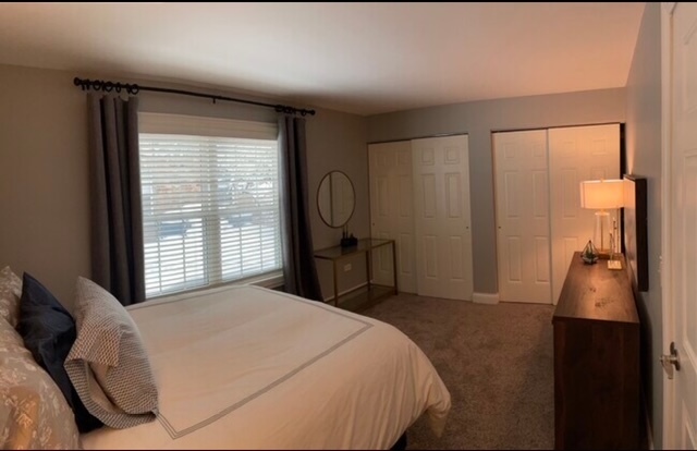 35 Foxcroft Road, Unit 103 Naperville, IL 60565 - Photo 8 of 11 a bed room with a bed and a television