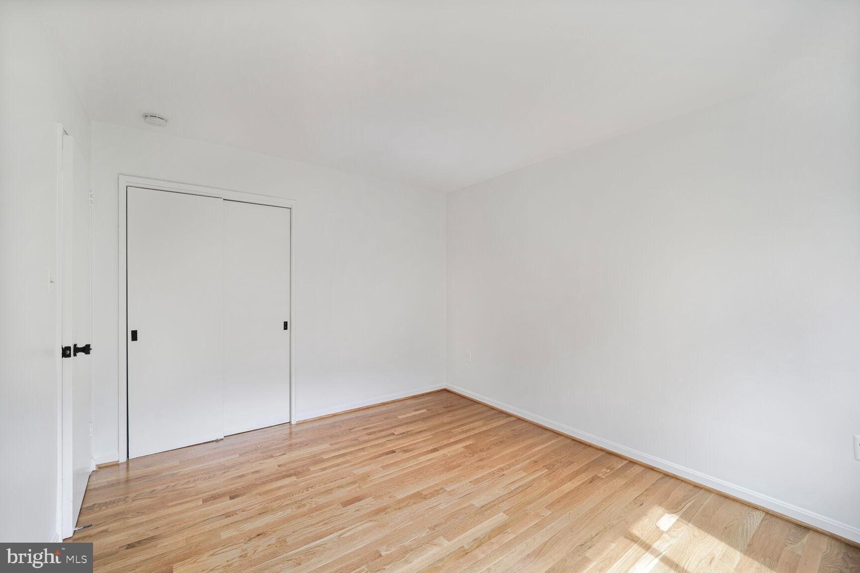 4114 Davis Place Northwest, Unit 311 Washington, DC 20007 - Photo 14 of 37 a view of empty room with wooden floor
