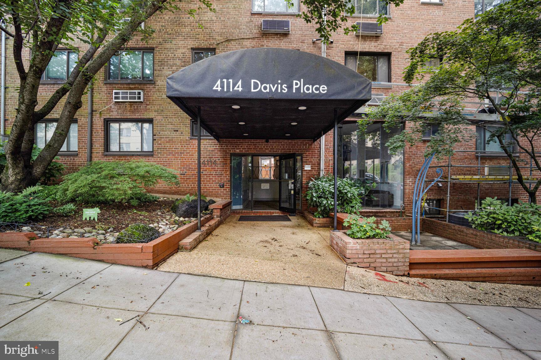 4114 Davis Place Northwest, Unit 311 Washington, DC 20007 - Photo 17 of 37 a view of a brick house with plants and large trees