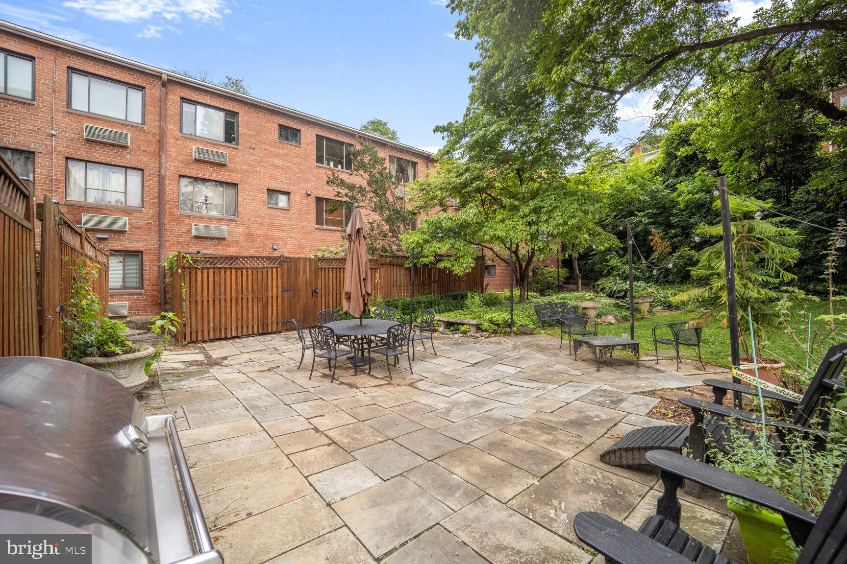 4114 Davis Place Northwest, Unit 311 Washington, DC 20007 - Photo 20 of 37 a view of backyard with outdoor seating and plants