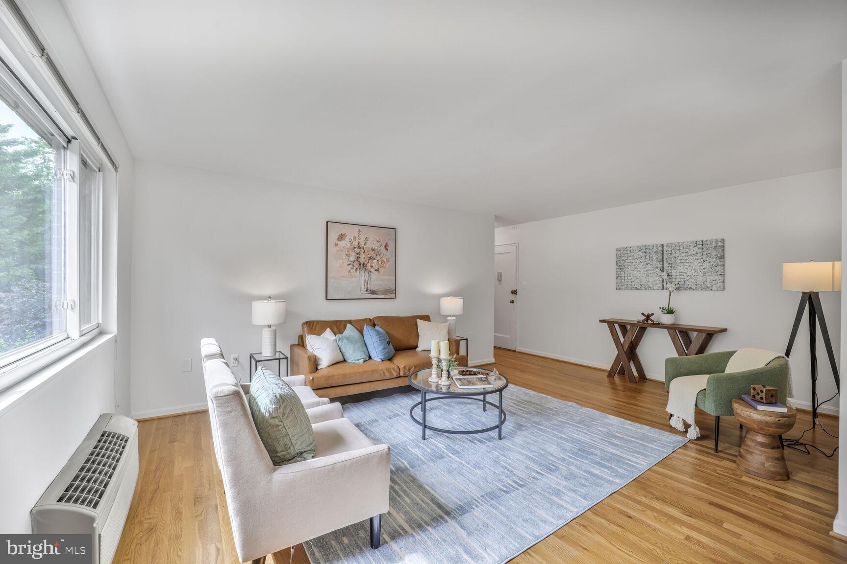 4114 Davis Place Northwest, Unit 311 Washington, DC 20007 - Photo 2 of 37 a living room with furniture and a wooden floor