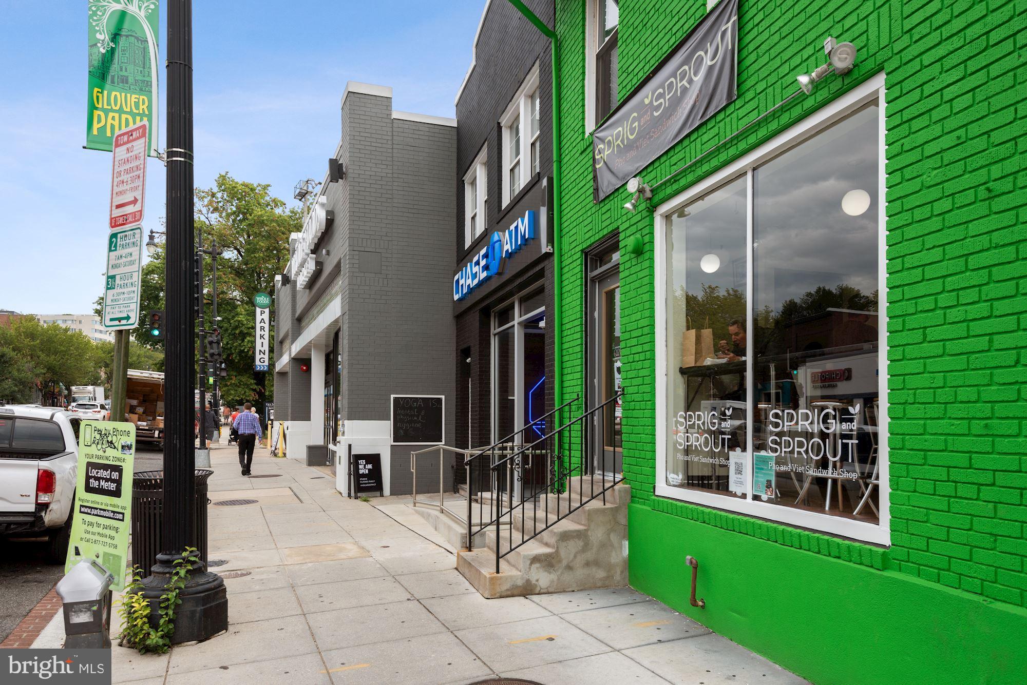 4114 Davis Place Northwest, Unit 311 Washington, DC 20007 - Photo 33 of 37 a view of tall brick building with a yard and potted plants