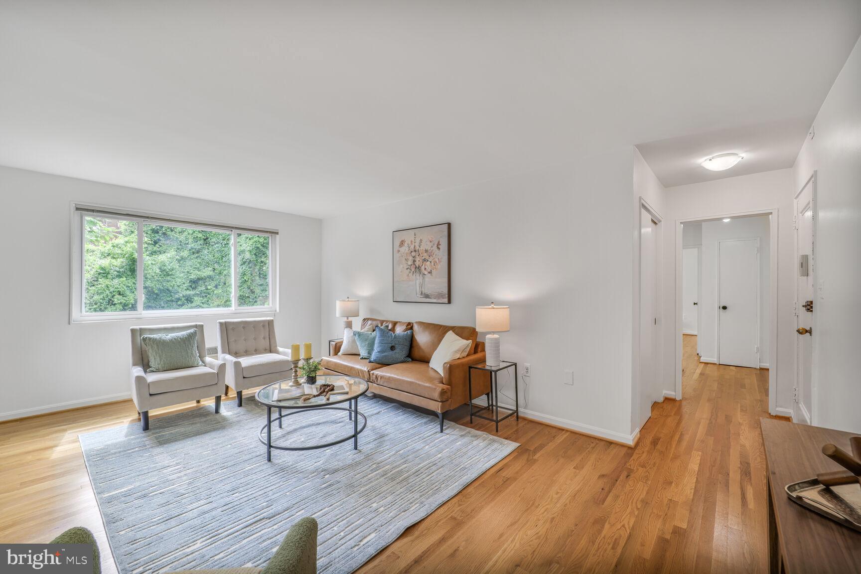 4114 Davis Place Northwest, Unit 311 Washington, DC 20007 - Photo 8 of 37 a living room with furniture and a wooden floor