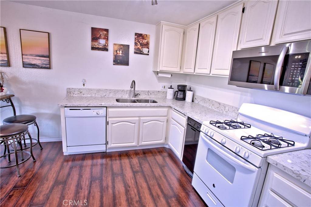 1083 Lakeview Terrace Azusa, CA 91702 - Photo 23 of 36 a kitchen with a stove a sink and a microwave
