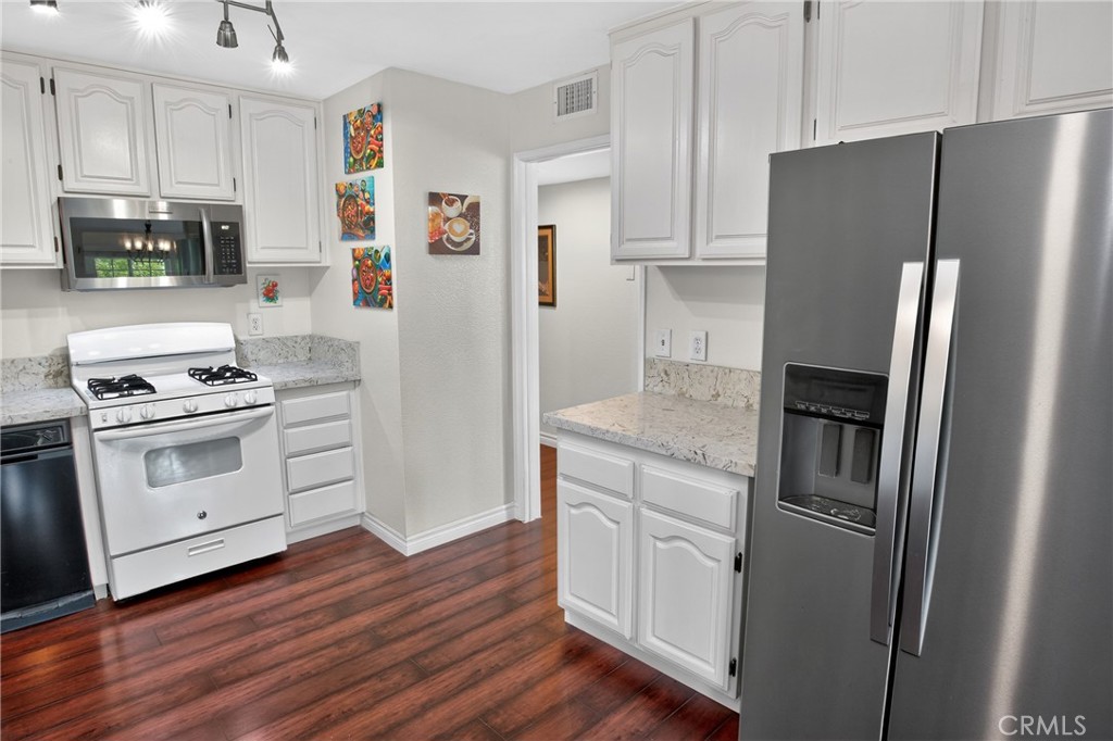 1083 Lakeview Terrace Azusa, CA 91702 - Photo 24 of 36 a kitchen with stainless steel appliances a refrigerator stove and microwave