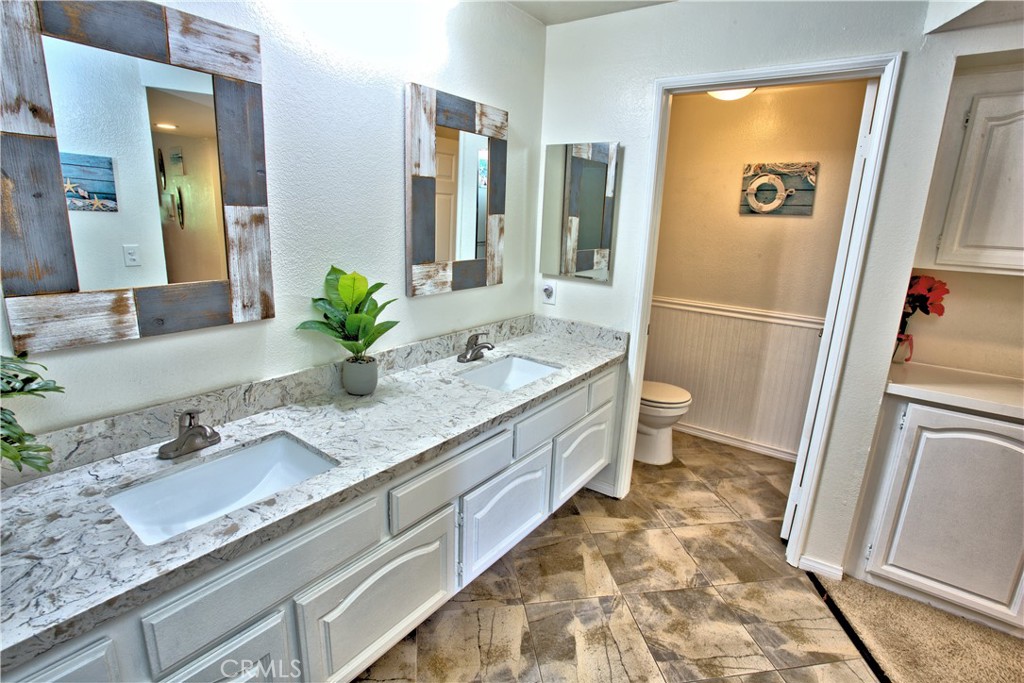 1083 Lakeview Terrace Azusa, CA 91702 - Photo 28 of 36 a spacious bathroom with a granite countertop sink and a mirror