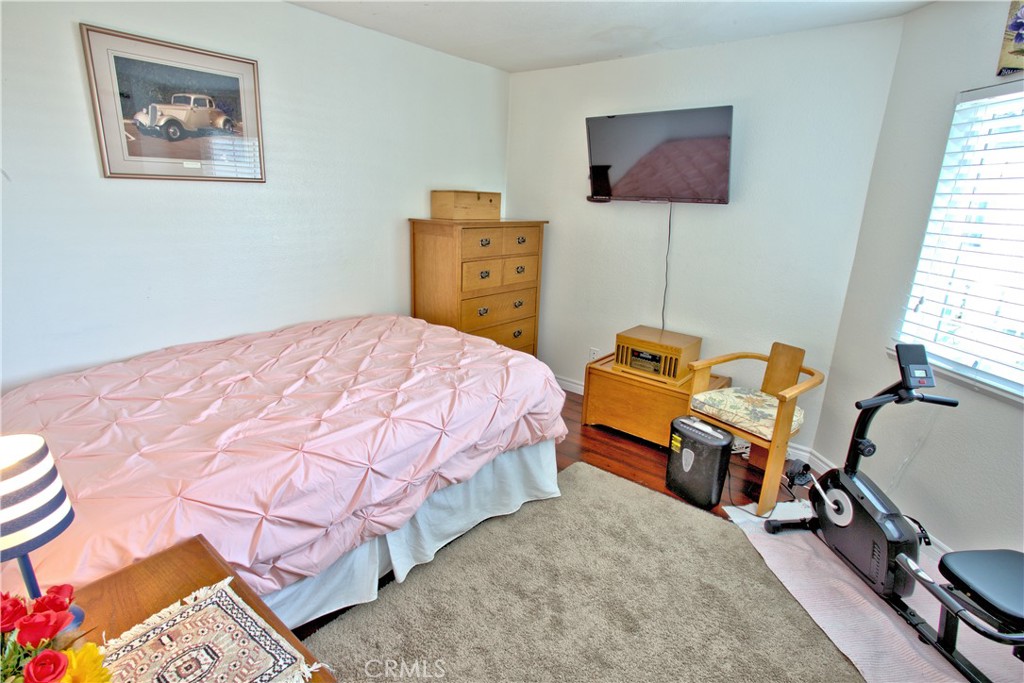 1083 Lakeview Terrace Azusa, CA 91702 - Photo 30 of 36 a bedroom with a bed and wooden floor