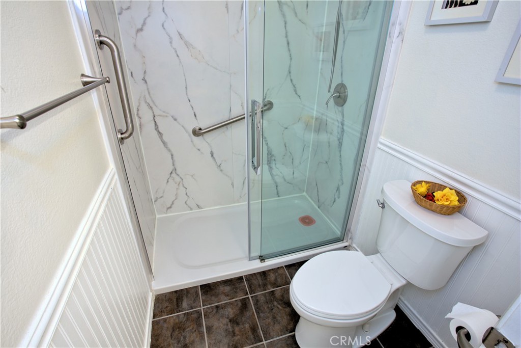 1083 Lakeview Terrace Azusa, CA 91702 - Photo 32 of 36 a white toilet sitting next to a bathroom sink and a shower