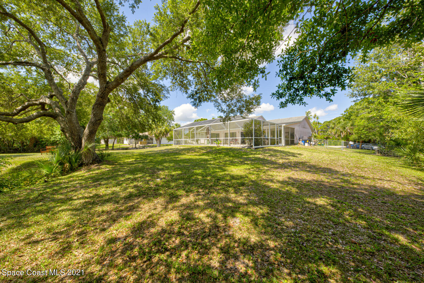 2225 Corey Road Malabar, FL 32950 - Photo 11 of 62 a swimming pool with outdoor seating and yard