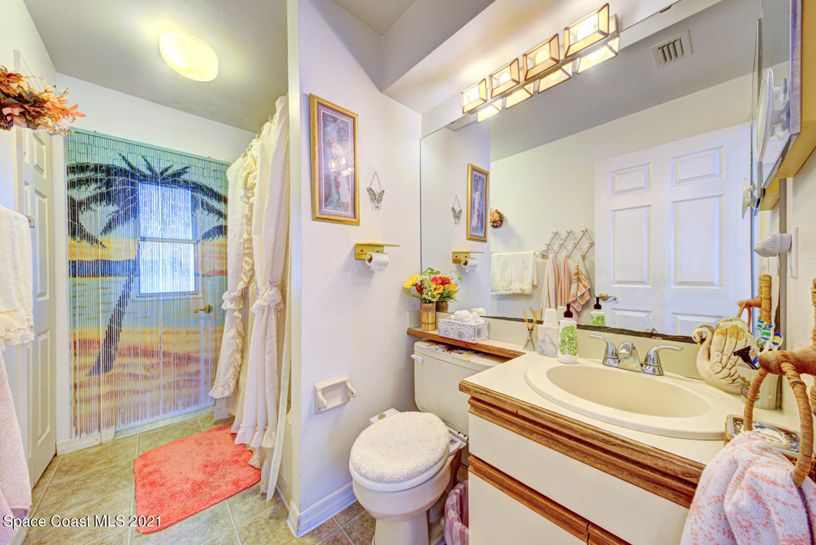2225 Corey Road Malabar, FL 32950 - Photo 17 of 62 a bathroom with a sink toilet and shower