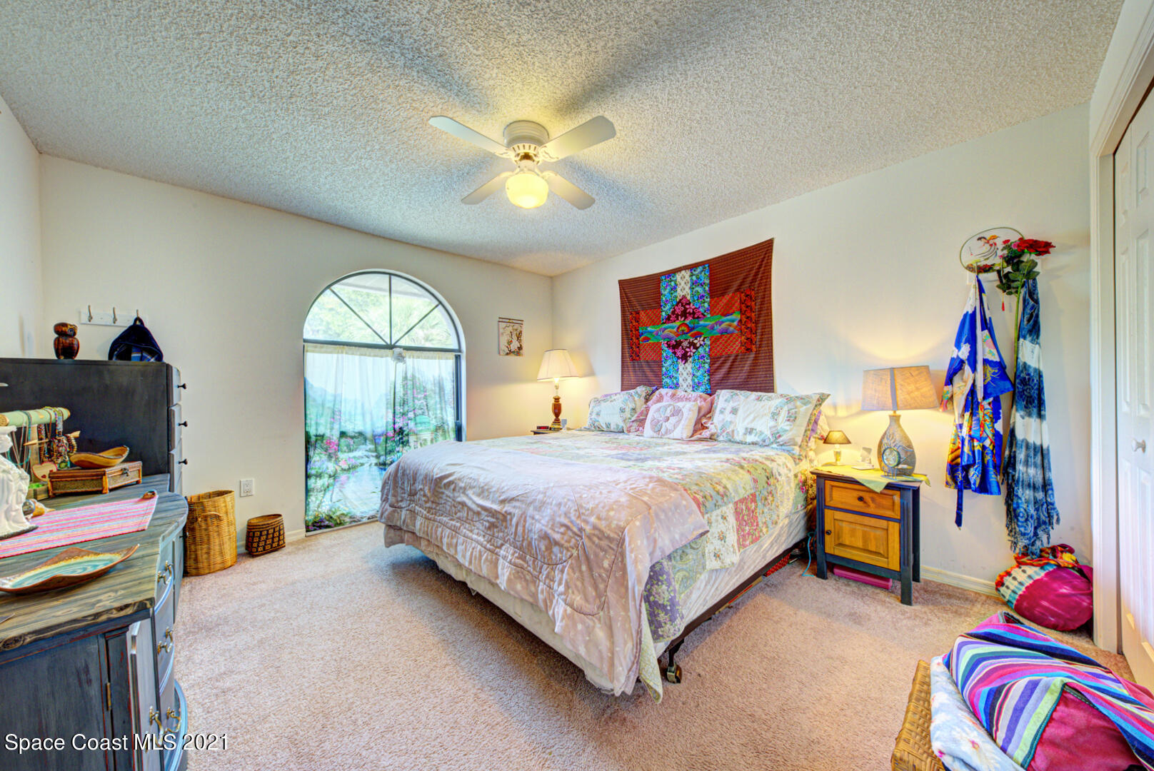2225 Corey Road Malabar, FL 32950 - Photo 18 of 62 a bedroom with a bed and a chandelier