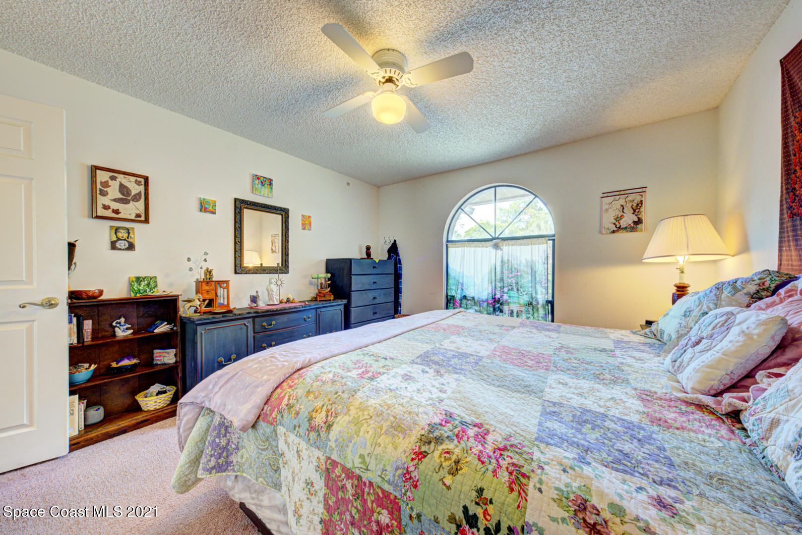 2225 Corey Road Malabar, FL 32950 - Photo 19 of 62 a bedroom with a bed and a chandelier