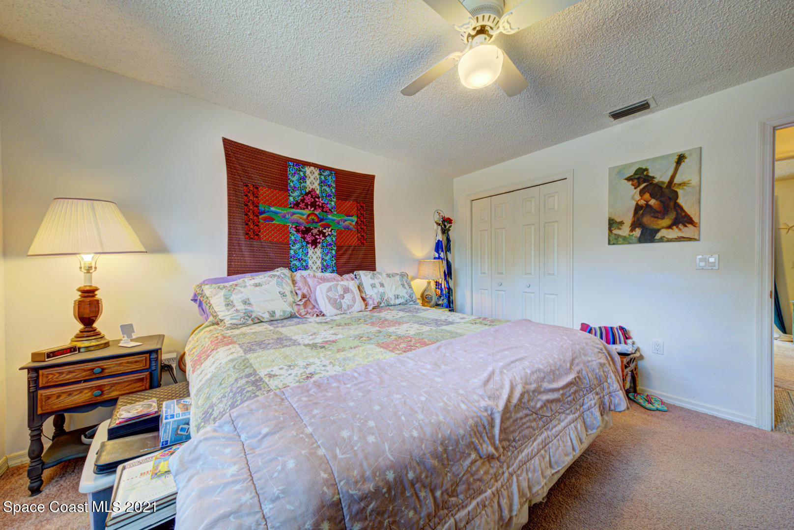 2225 Corey Road Malabar, FL 32950 - Photo 20 of 62 a bedroom with a bed and a lamp on dresser