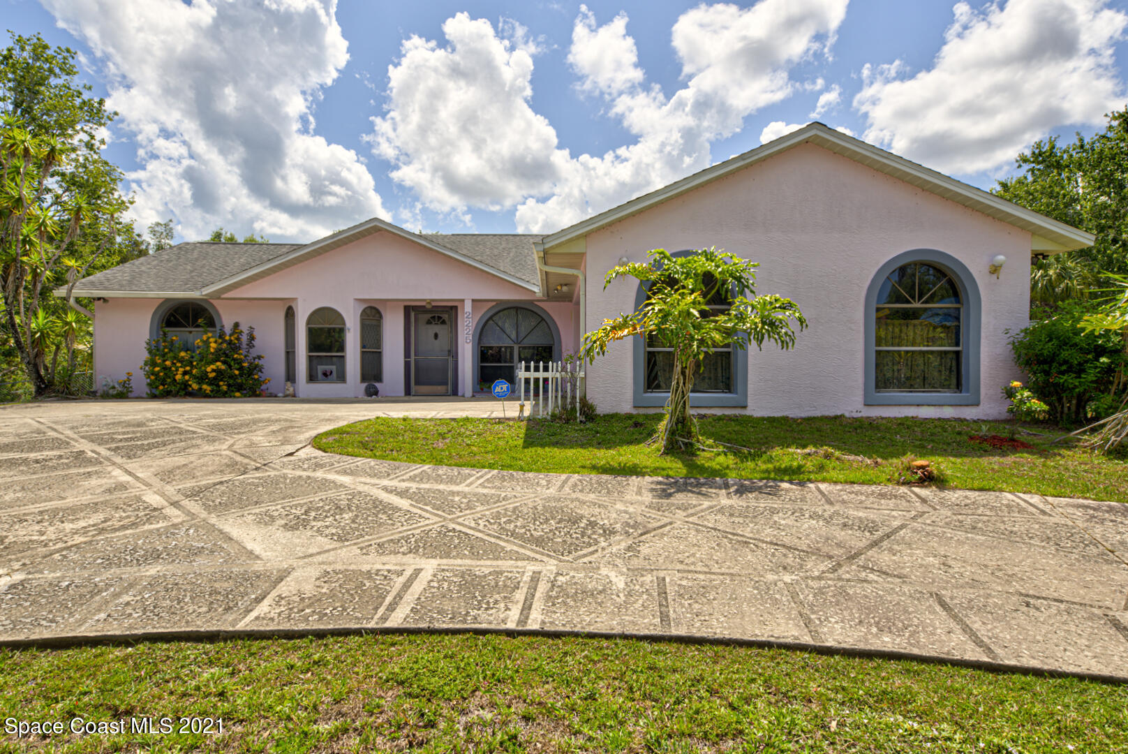 2225 Corey Road Malabar, FL 32950 - Photo 3 of 62 a front view of a house with a yard and potted plants