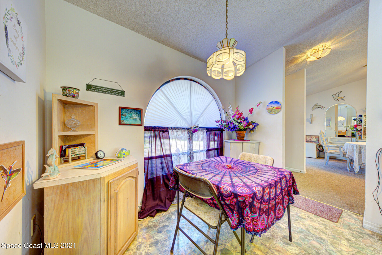 2225 Corey Road Malabar, FL 32950 - Photo 24 of 62 a view of a dining room with furniture and a chandelier