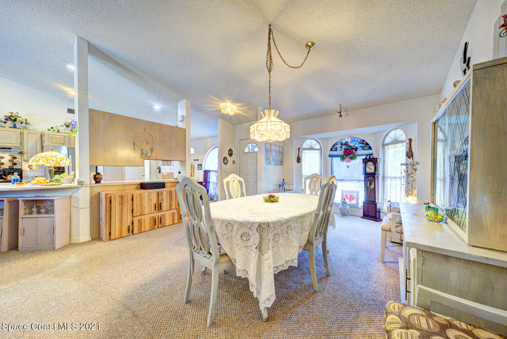 2225 Corey Road Malabar, FL 32950 - Photo 27 of 62 a dining area with a table chairs and a kitchen view