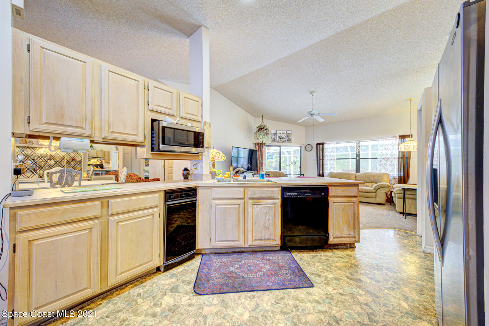 2225 Corey Road Malabar, FL 32950 - Photo 31 of 62 a kitchen with a refrigerator stove top oven and sink