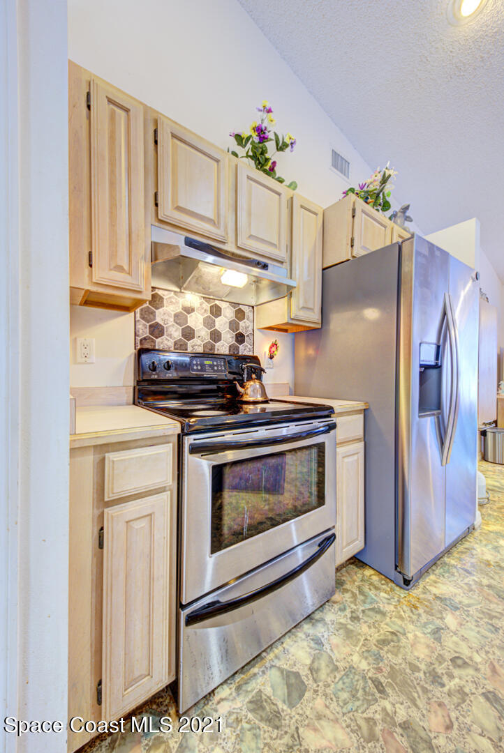 2225 Corey Road Malabar, FL 32950 - Photo 34 of 62 a stove top oven sitting inside of a kitchen