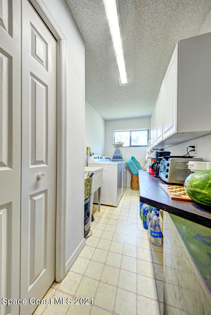 2225 Corey Road Malabar, FL 32950 - Photo 36 of 62 a living room with stainless steel appliances lots of counter space and a window