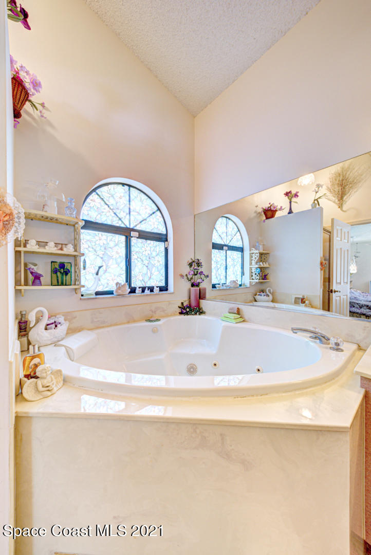 2225 Corey Road Malabar, FL 32950 - Photo 41 of 62 a spacious bathroom with a tub and a large window