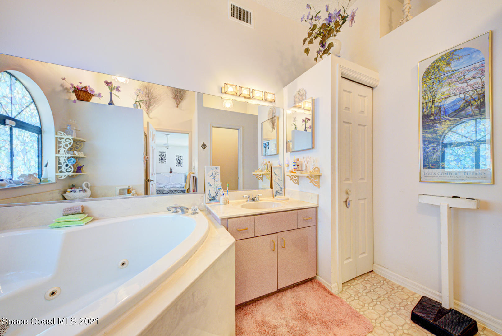 2225 Corey Road Malabar, FL 32950 - Photo 44 of 62 a bathroom with a tub sink and mirror