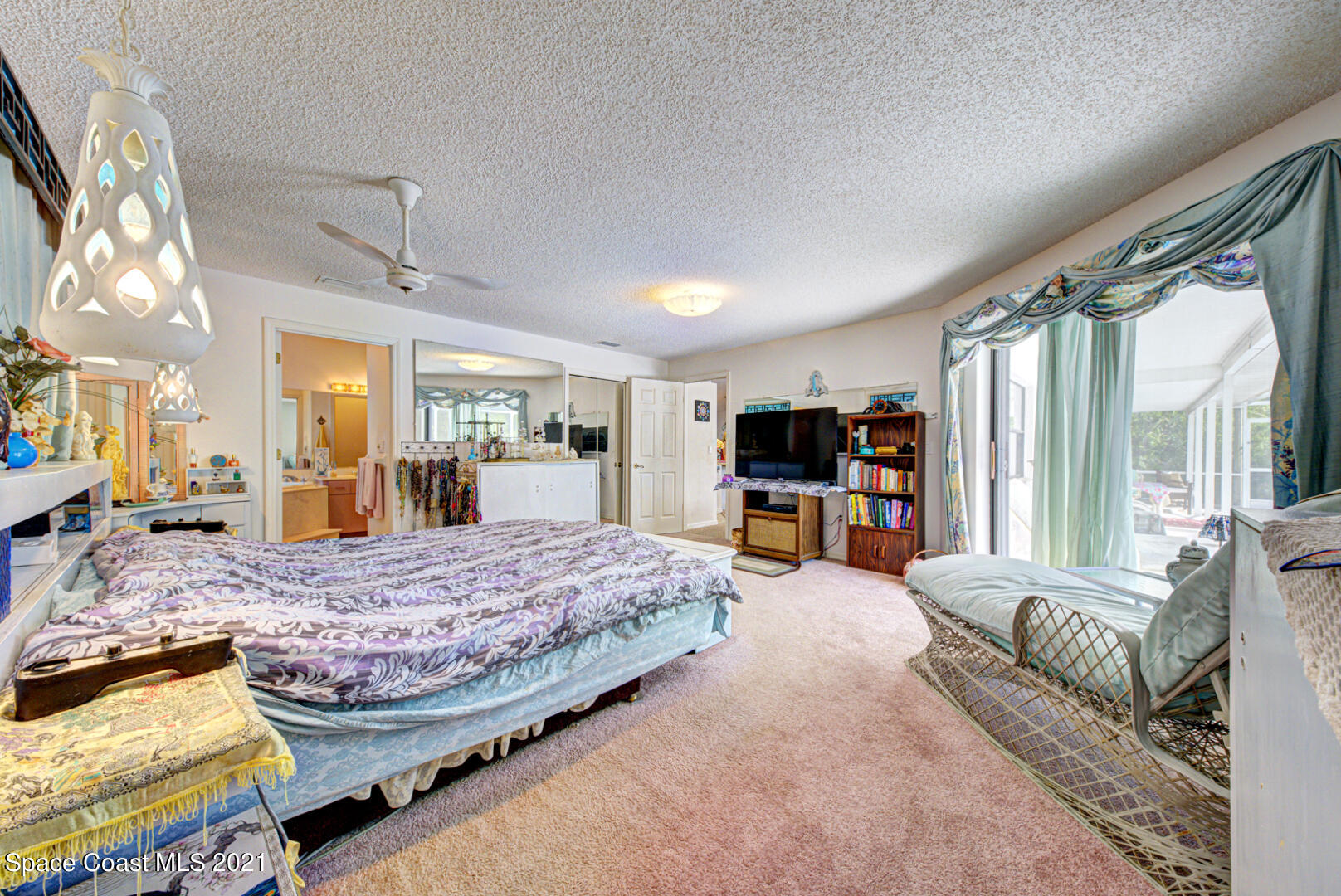 2225 Corey Road Malabar, FL 32950 - Photo 46 of 62 a bedroom with a large bed and a large window