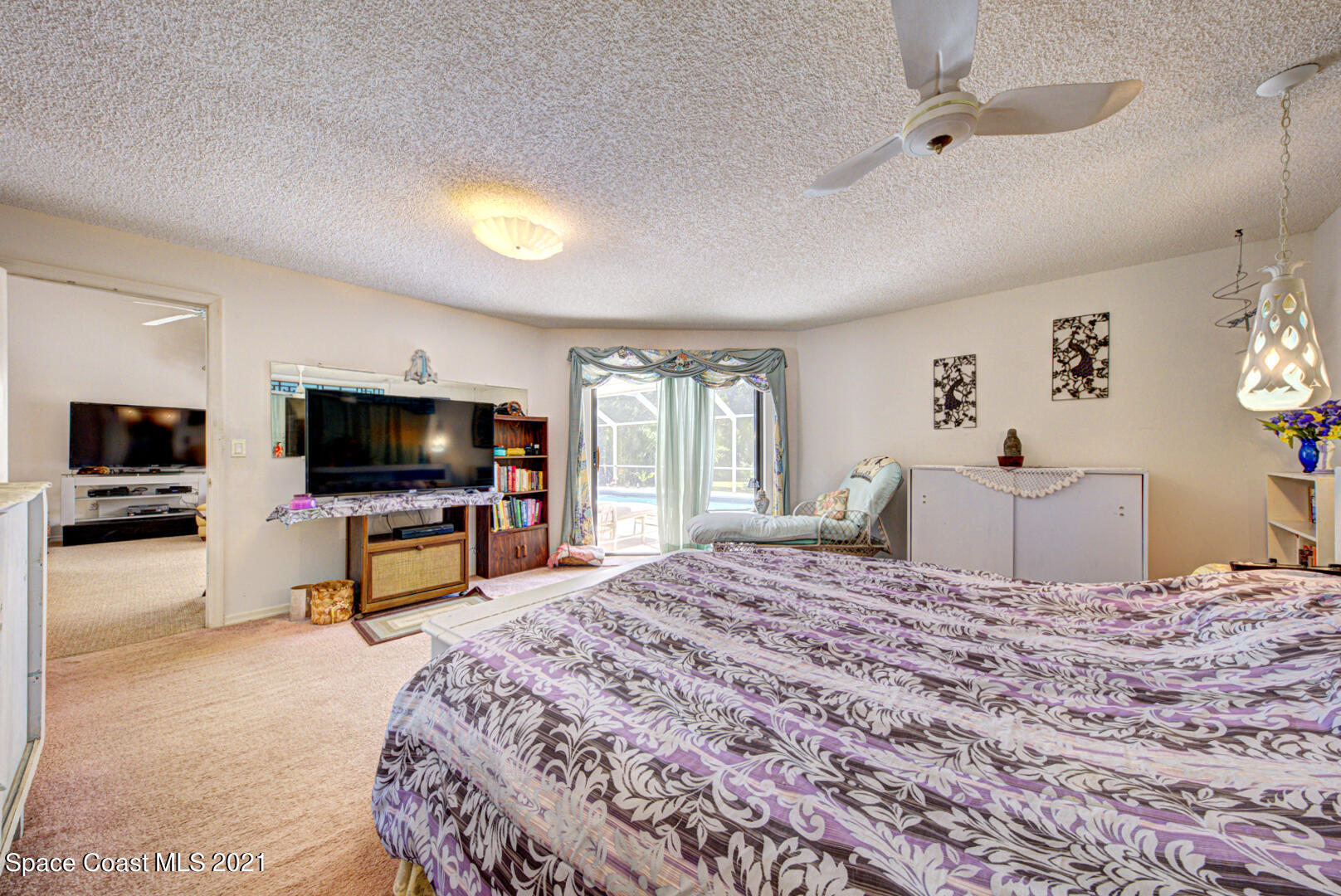 2225 Corey Road Malabar, FL 32950 - Photo 47 of 62 a bedroom with a bed and a flat screen tv