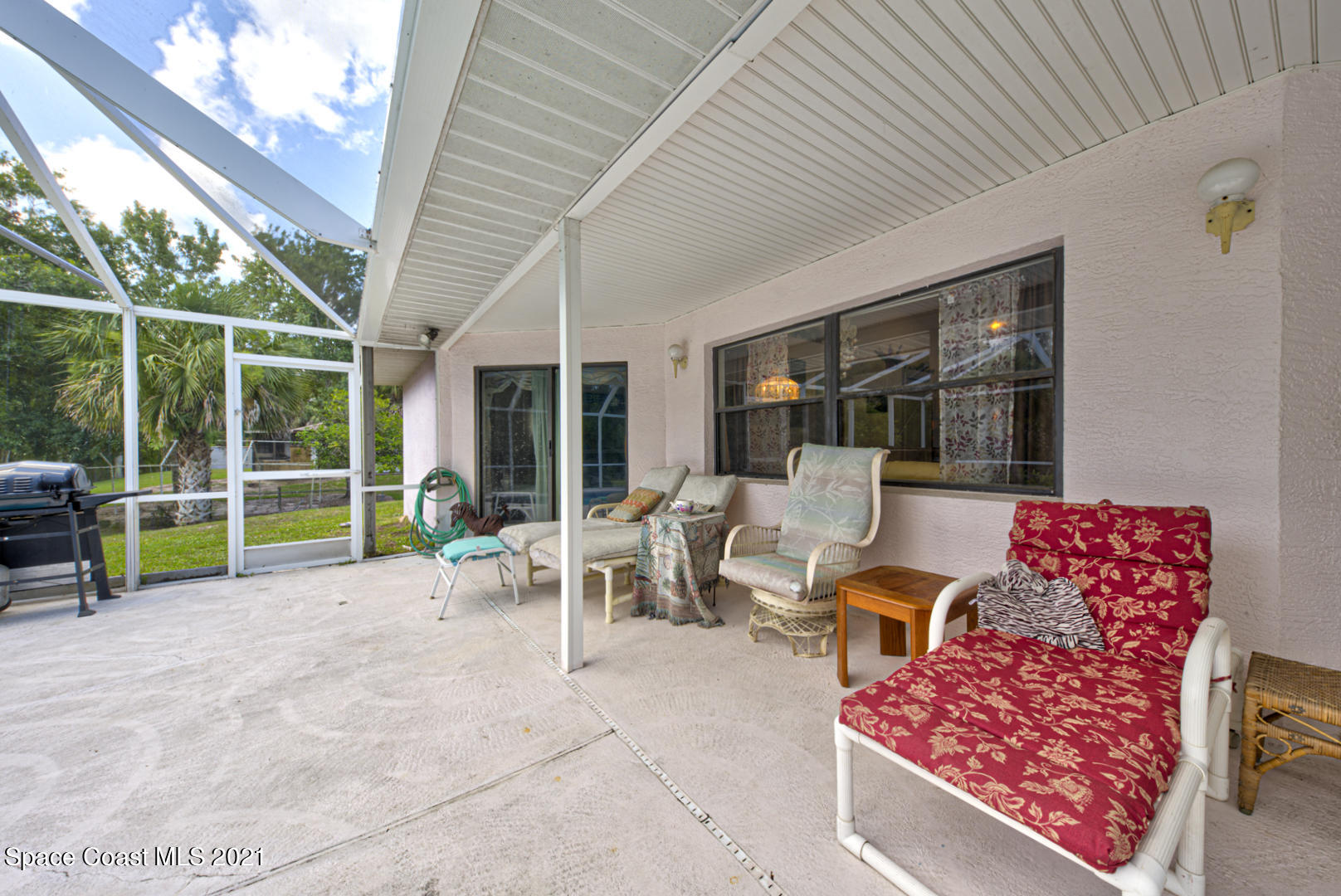2225 Corey Road Malabar, FL 32950 - Photo 56 of 62 a view of a patio with a table chairs and a backyard