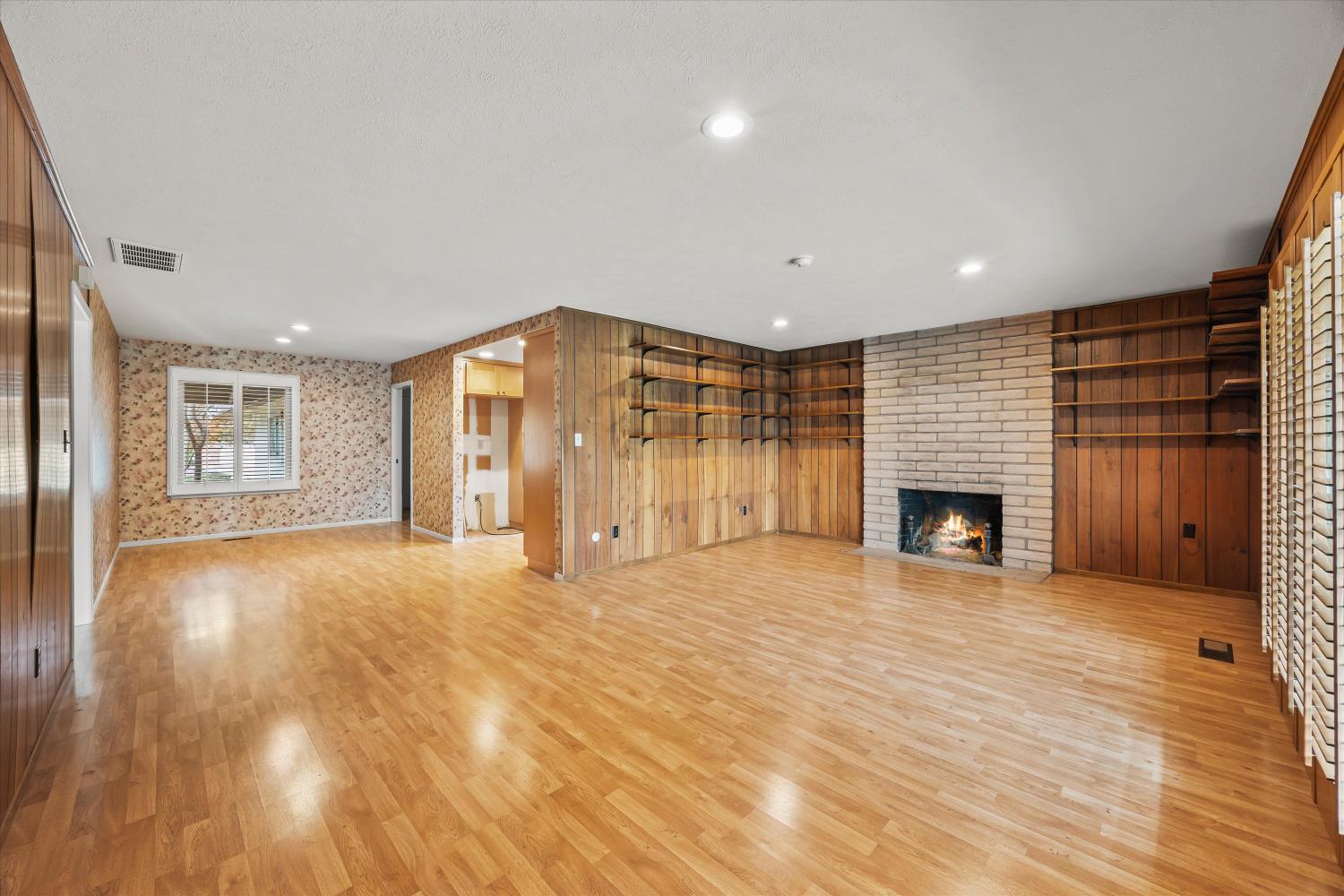4808 Sherlock Way Carmichael, CA 95608 - Photo 13 of 45 a view of empty room with wooden floor and fireplace