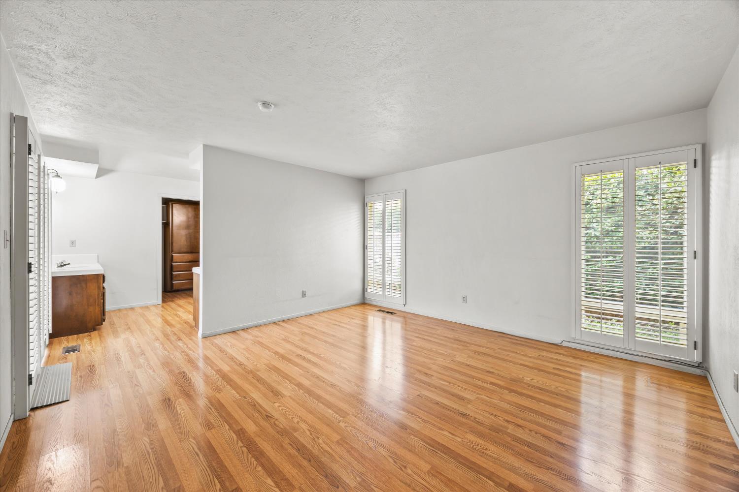 4808 Sherlock Way Carmichael, CA 95608 - Photo 22 of 45 a view of an empty room with wooden floor and a window