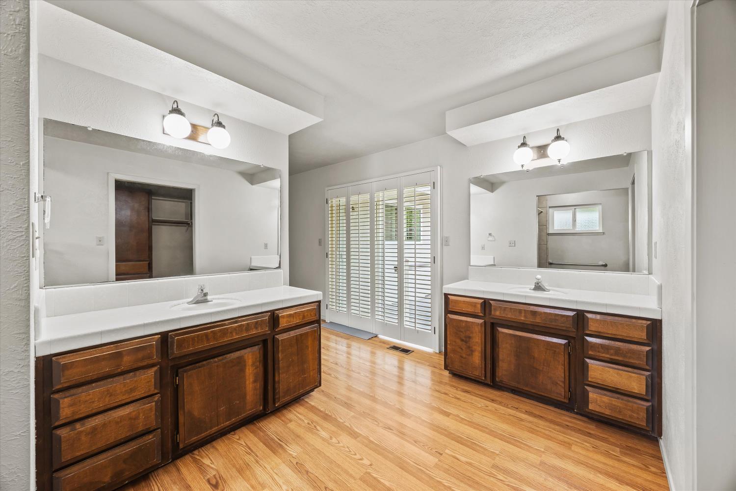 4808 Sherlock Way Carmichael, CA 95608 - Photo 24 of 45 a spacious bathroom with a granite countertop double vanity sink and a mirror