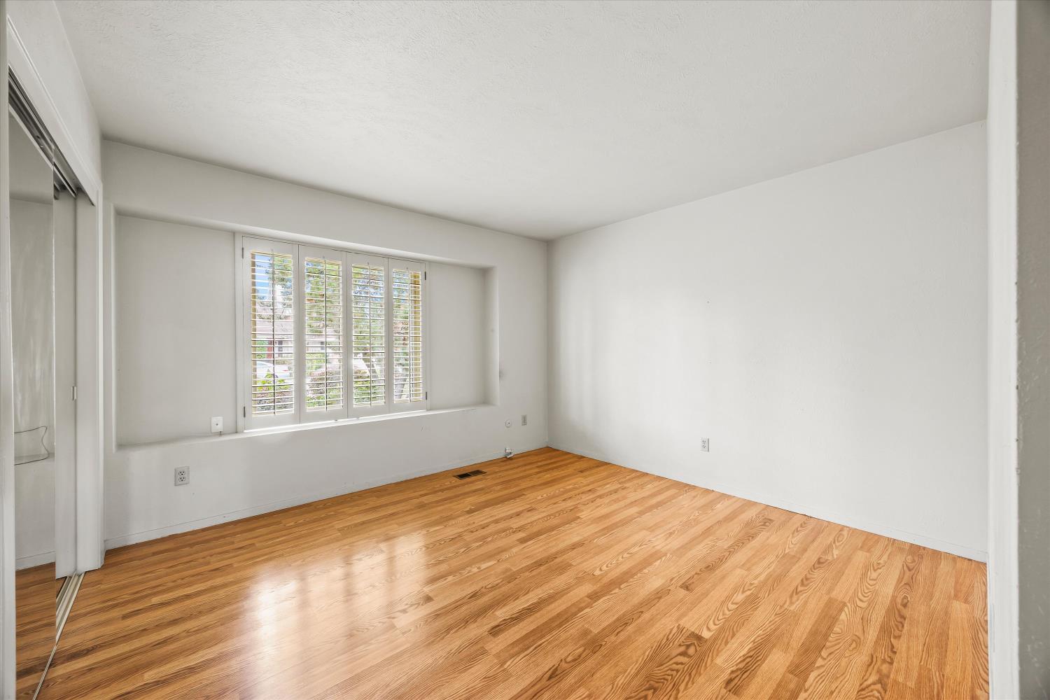 4808 Sherlock Way Carmichael, CA 95608 - Photo 27 of 45 a view of empty room with wooden floor and fan