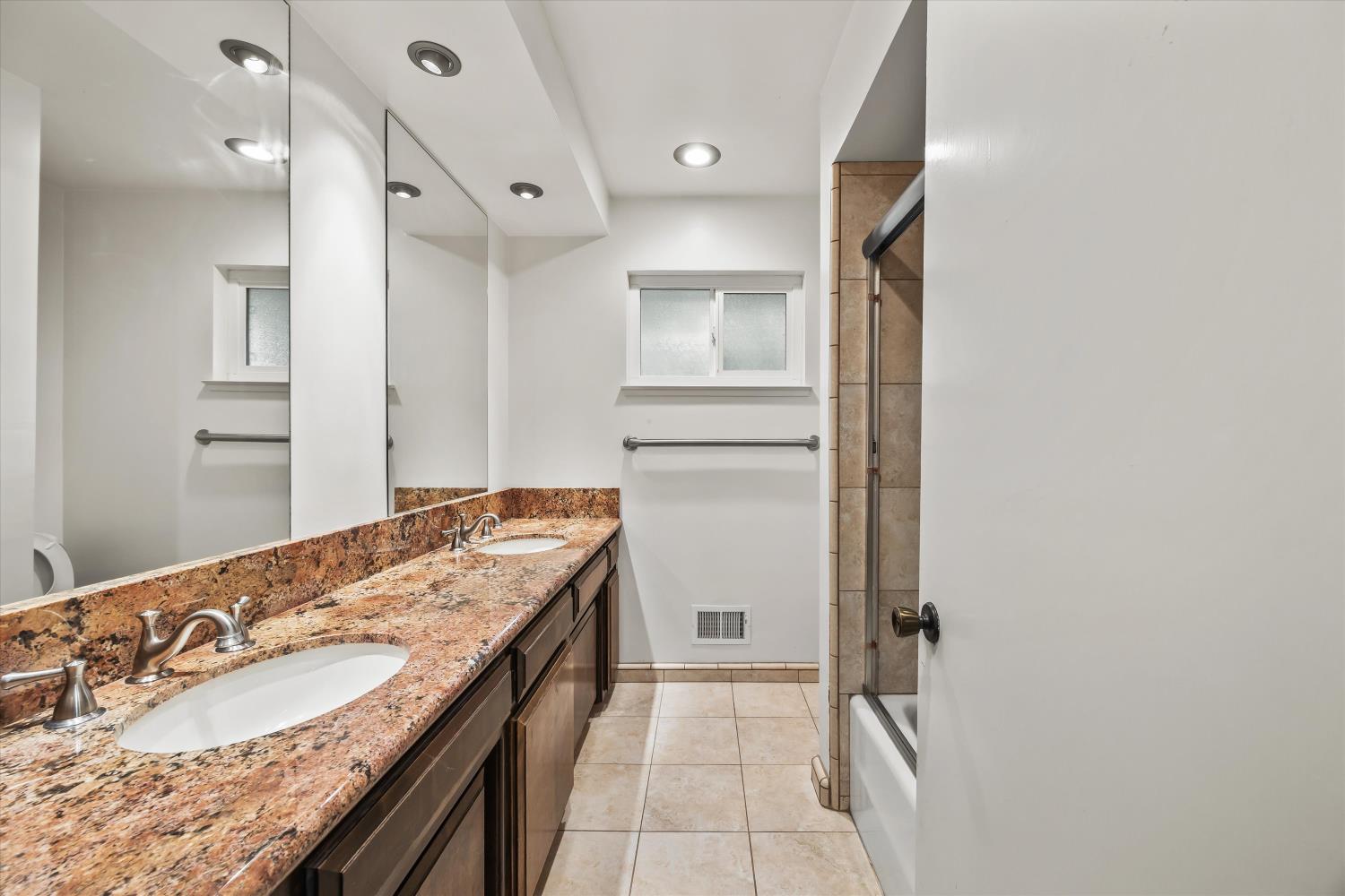 4808 Sherlock Way Carmichael, CA 95608 - Photo 29 of 45 a bathroom with a granite countertop sink and a mirror