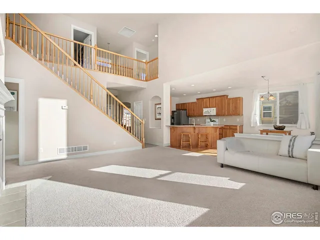 a living room with furniture and a dining table