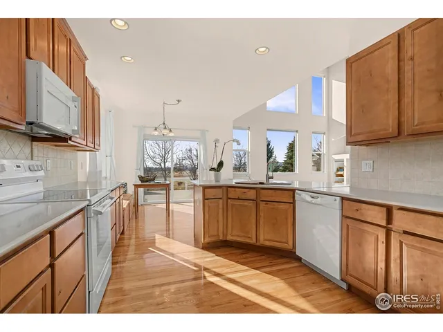 a kitchen with stainless steel appliances kitchen island granite countertop a sink and cabinets