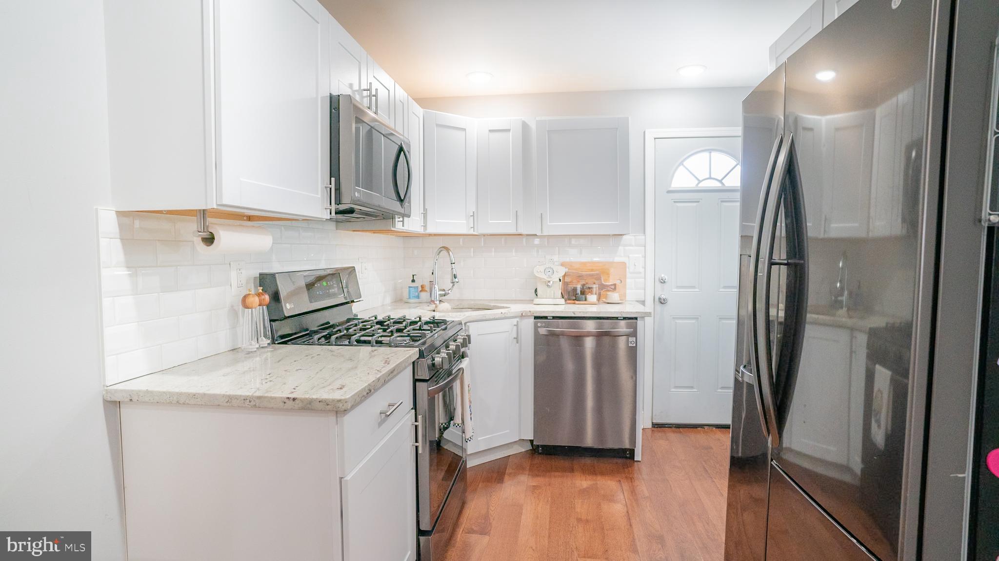 2438 West Seybert Street Philadelphia, PA 19121 - Photo 4 of 21 a kitchen with a refrigerator sink and stove
