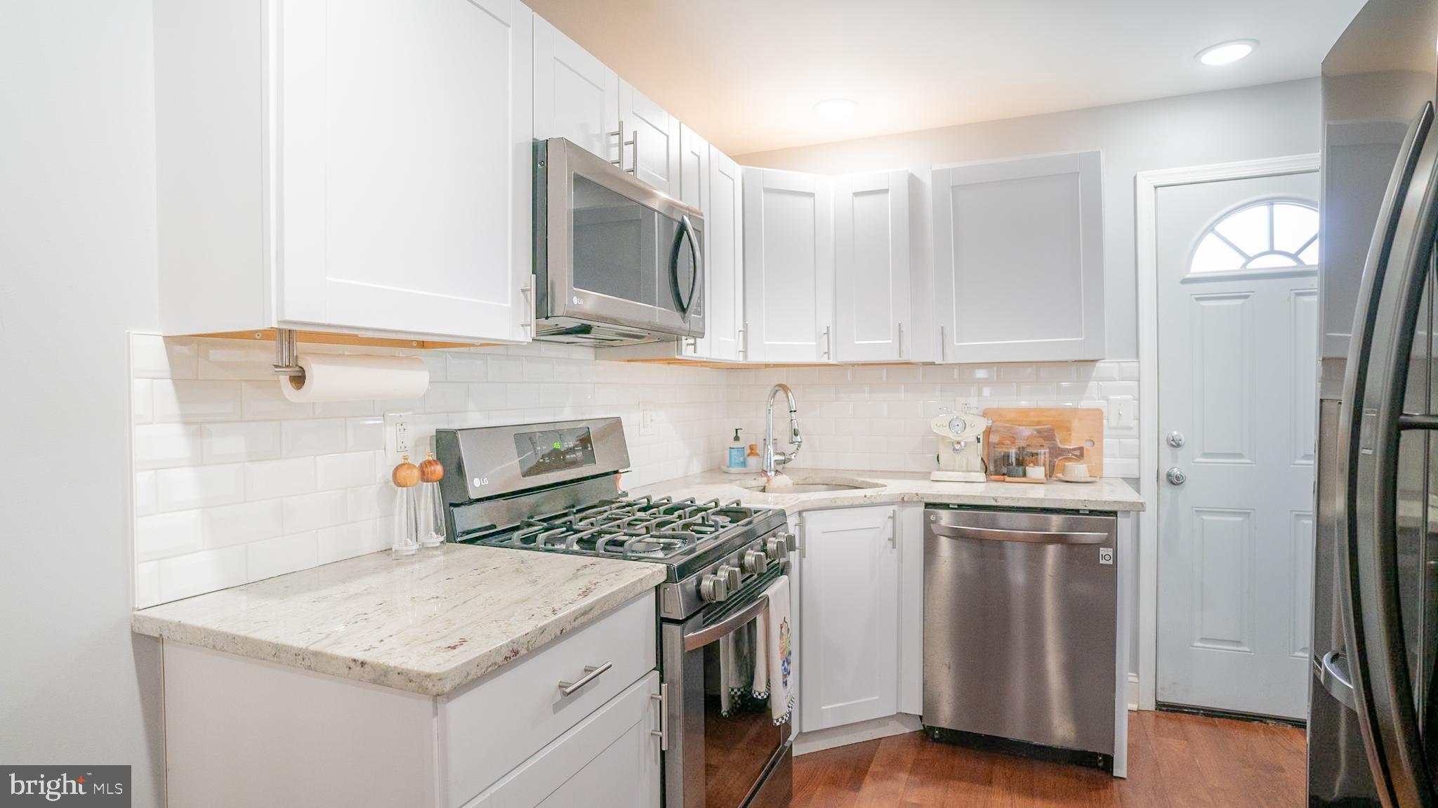 2438 West Seybert Street Philadelphia, PA 19121 - Photo 5 of 21 a kitchen with stainless steel appliances granite countertop a sink stove and refrigerator