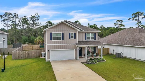 a front view of house with yard and green space