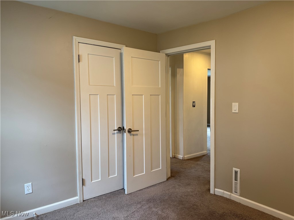 1139 Kessel Avenue Akron, OH 44310 - Photo 25 of 36 Unfurnished bedroom featuring carpet, baseboards, and a closet