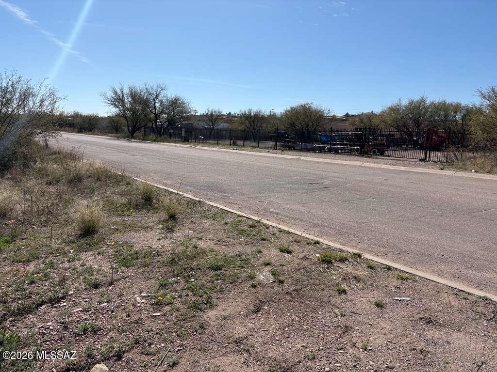 1179 Circulo Mercado, Unit 56 Rio Rico, AZ 85648 - Photo 6 of 6 a view of a dry yard with wooden fence
