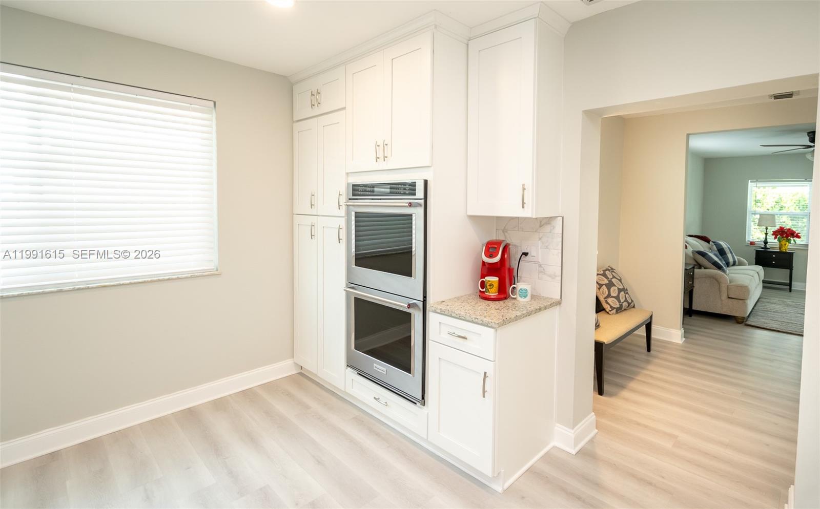 2230 Southwest 60th Court Miami, FL 33155 - Photo 11 of 35 a view of a kitchen with stainless steel appliances wooden floor and a window