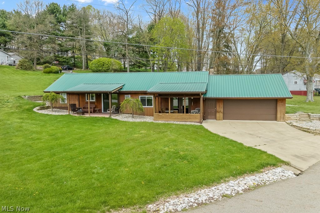 6939 Lakeview Road Hanoverton, OH 44423 - Photo 2 of 42 Ranch-style home with a front yard, a garage, and covered porch