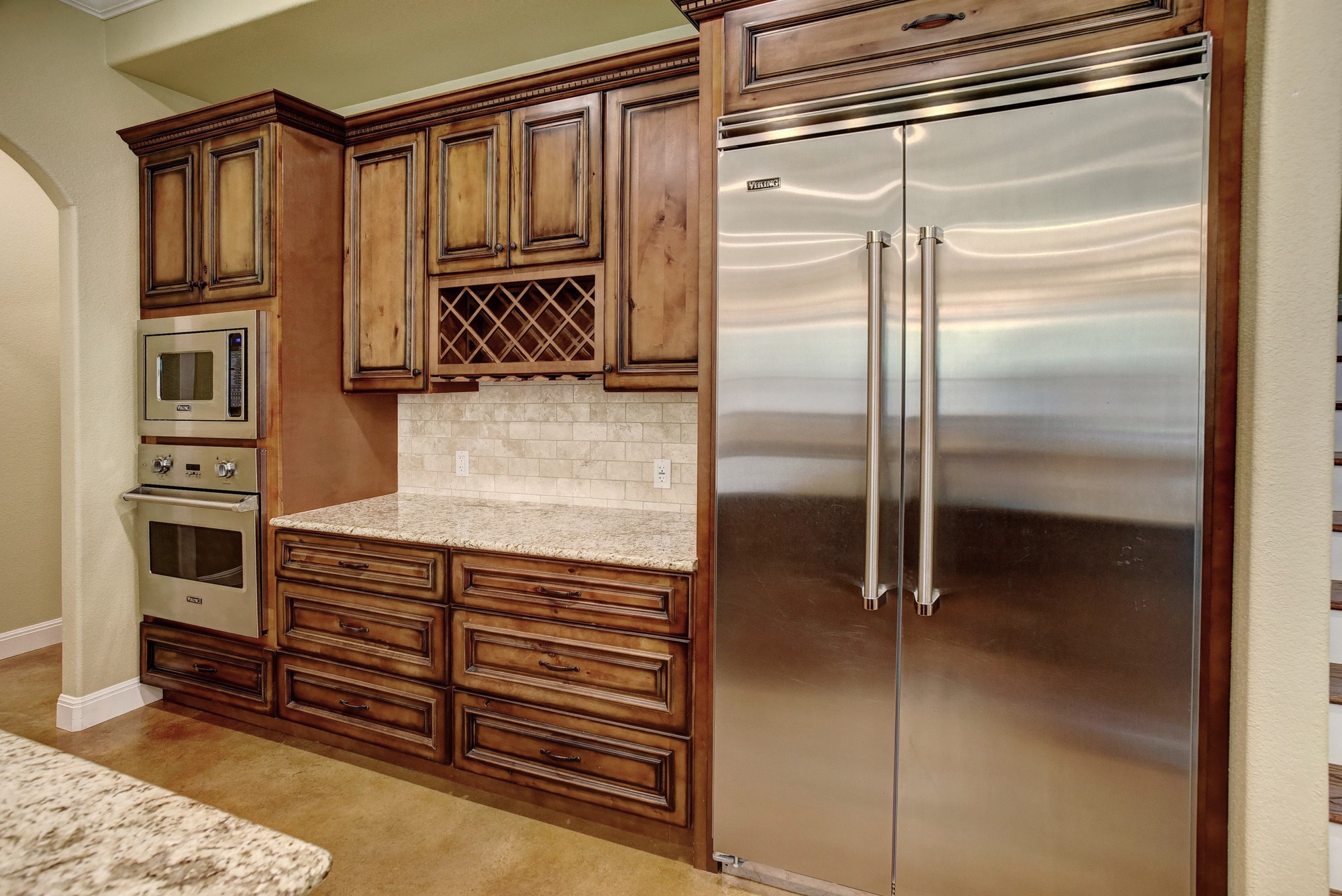 115 Pine Point Cove Elgin, TX 78621 - Photo 11 of 39 Culinary aspirations meet luxury in this meticulously designed kitchen with granite countertops and built-in appliances.